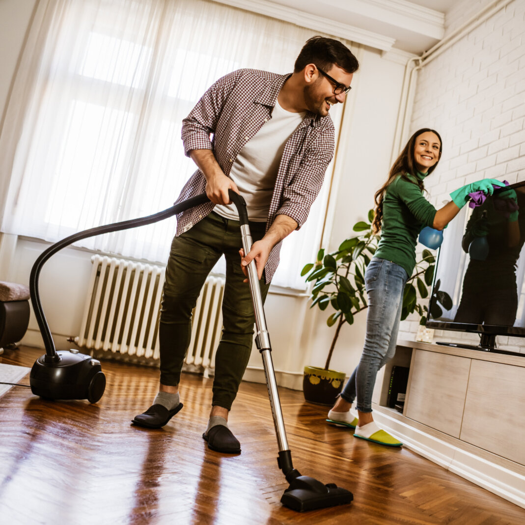 Happy couple cleaning their come