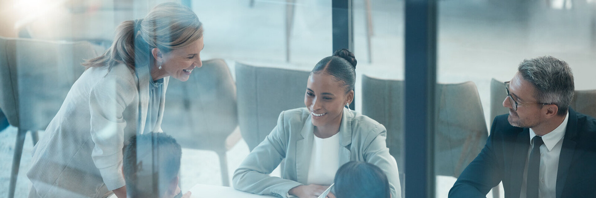 Leader, meeting and presentation with business people behind glass in a finance, data and growth discussion. Teamwork, collaboration and planning with executive team sharing goal, vision and idea.