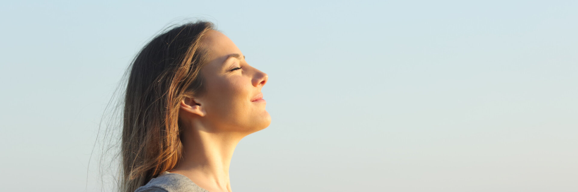 Side view portrait of a relaxed woman breathing fresh air on the beach